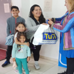 Enrique Cadena's wife hands blessing bag to parent in Ecuador