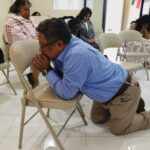 Man praying at Rodrigo Valdespino's church in Mexico