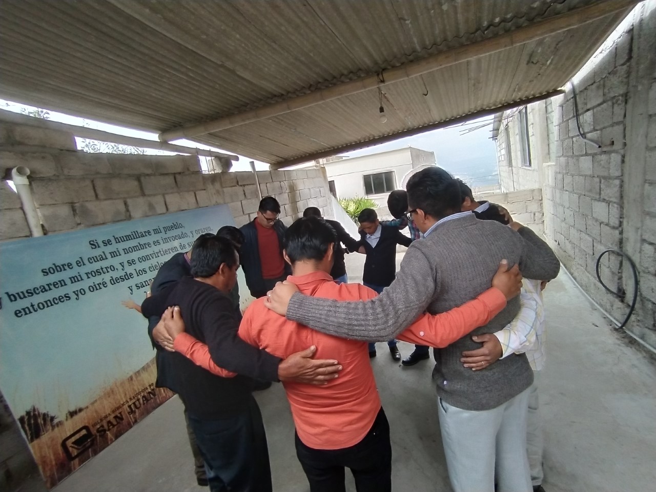 Gabriel Macancela prays with a group of believers
